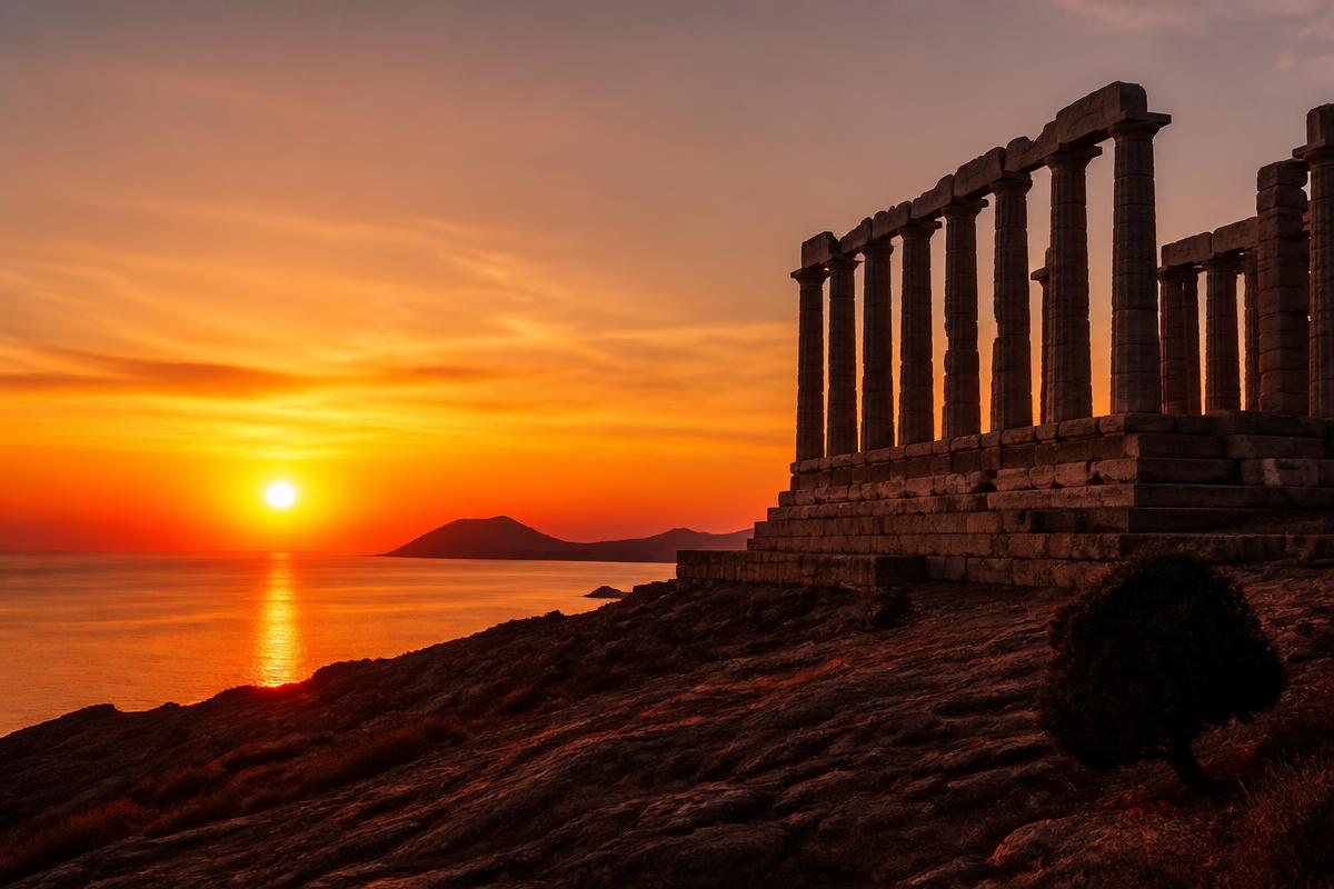 The marble columns of the Temple of Poseidon at Cape Sounion above the Aegean Sea at sunset