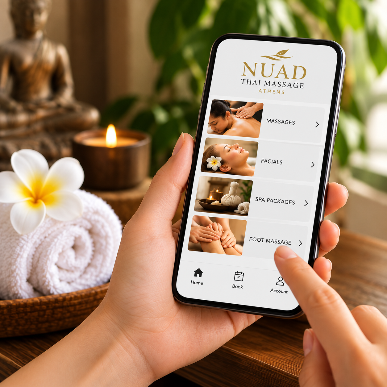 A hand holding a phone showing the Nuad Thai Massage Athens website — order anything online and we arrange it for you at no commission