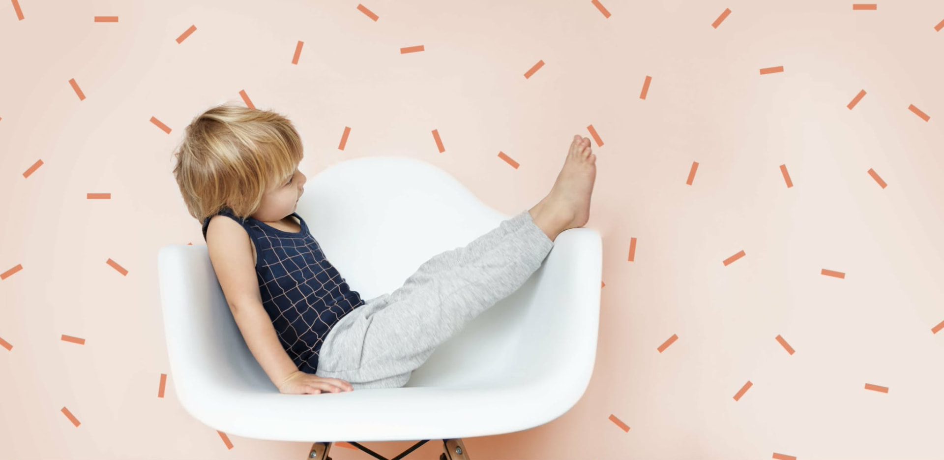 Small child relaxing barefoot in a chair