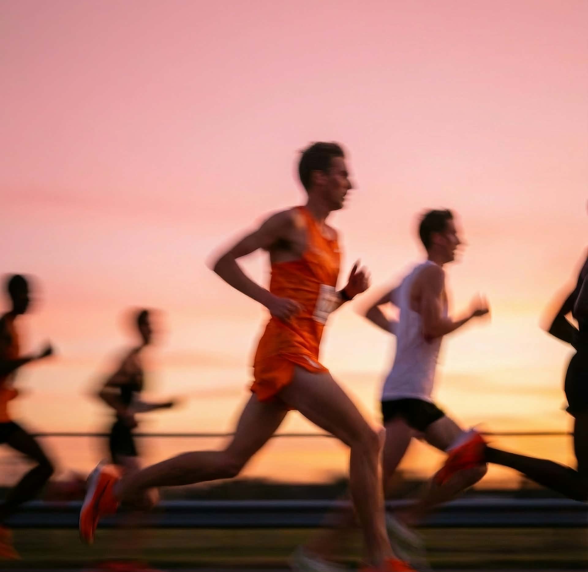 Marathon runners at sunset during the Athens race