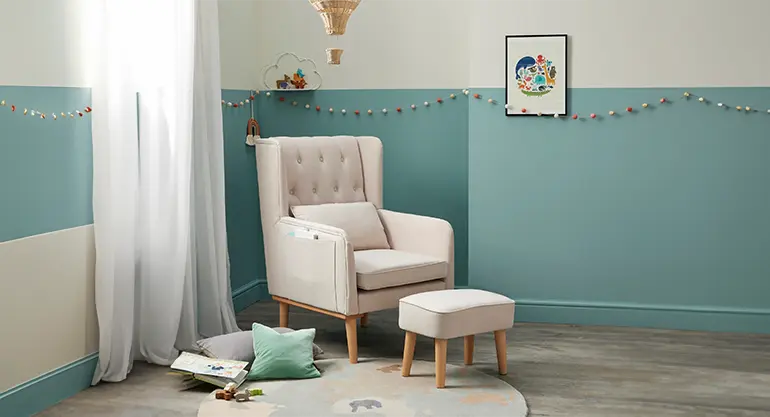 Cream nursing chair with stool in the nursing and baby changing room