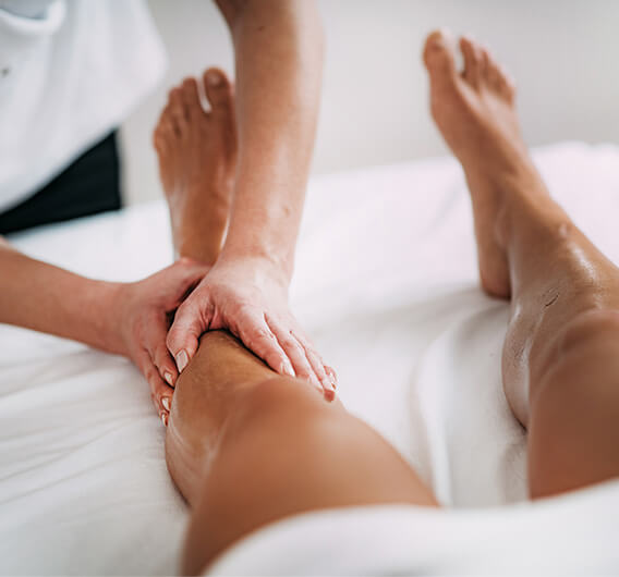 Therapist performing a deep calf and leg recovery massage