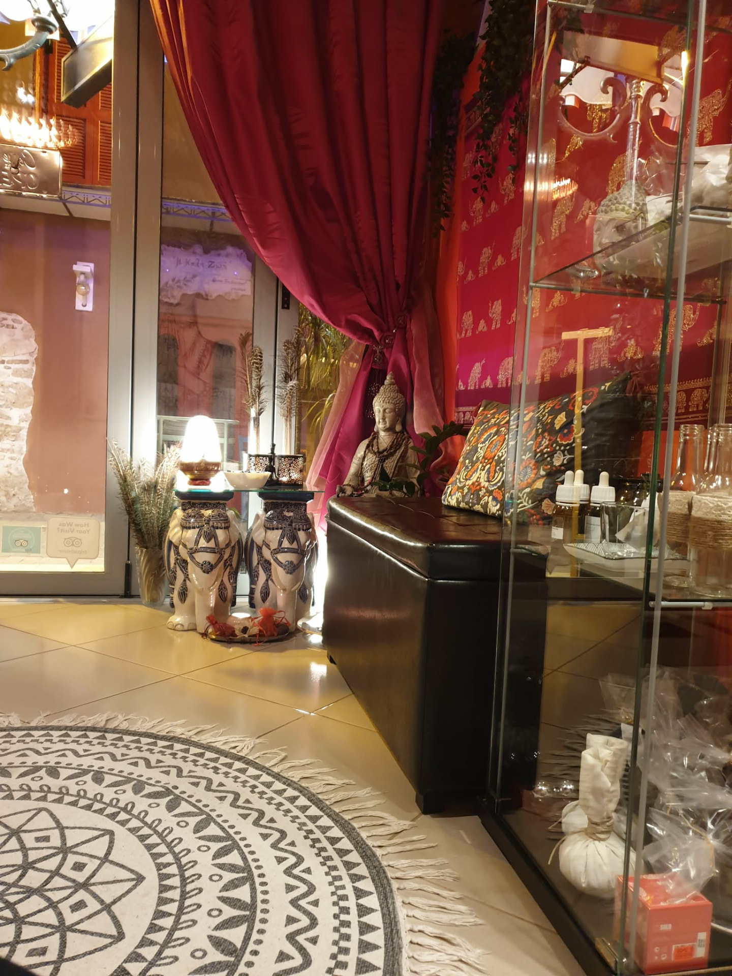 The original Nuad Thai Massage Athens interior near Syntagma: warm Thai silk, a Buddha figure, herbal compresses and welcome details in a quiet sanctuary